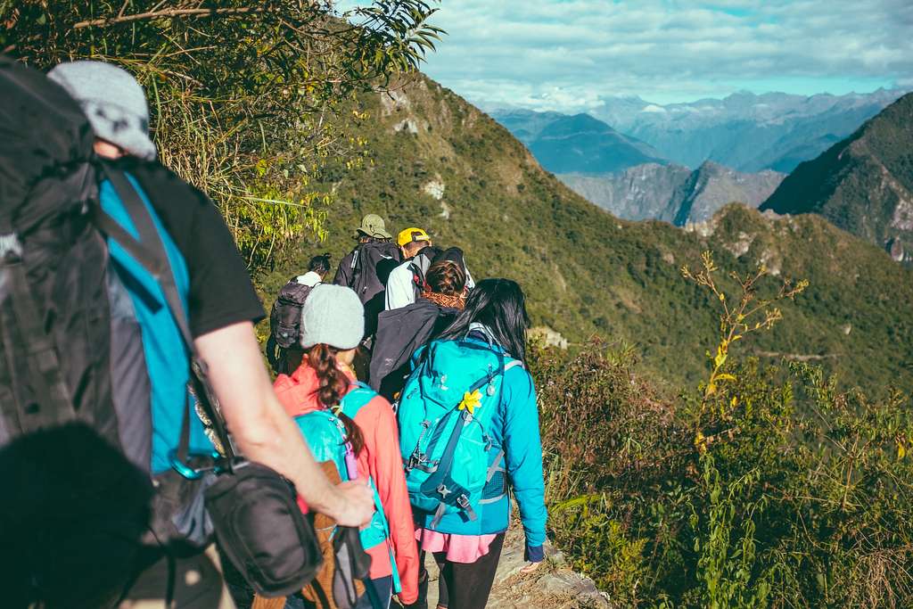 Young backpackers admiring Machu Picchu landscape.