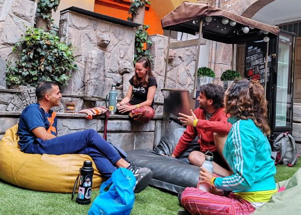 Solo traveler connecting with others in a lively hostel environment in Latin America.